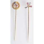 A gold pin the finial a ruby and diamond set flower together with a gold pin with a ruby,