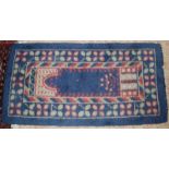 An Arts and Crafts style rug, the central blue arch with a leaf filled border, 137 x 70cm.
