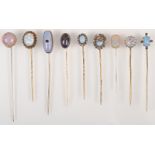 Nine various opalescent pins.