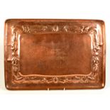 A Newlyn copper rectangular tray, the border with a procession of fish, seaweed and shell,