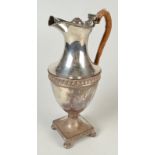 A Sheffield plated classical hot water jug of vase shape with cane bound handle,