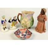 A Majolica jug, an Imari dish, two Staffordshire figures and a continental earthenware figure.