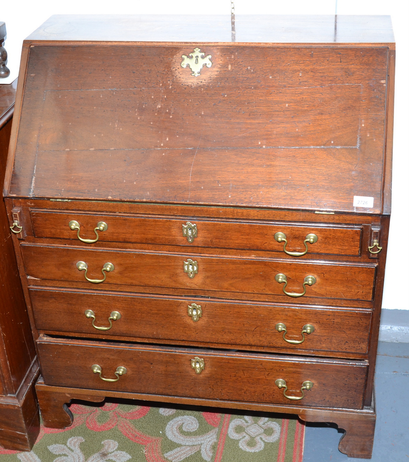 A George III mahogany slope front bureau of small proportions.