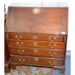 A George III mahogany slope front bureau of small proportions.