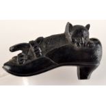 A Victorian black vulcanite brooch in the form of a cat in a shoe,