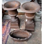 A pair of cast iron urns, height 67cm including separate square bases,