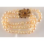 A triple strand pearl bracelet with 9ct.