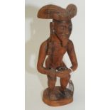 A Sumatran carved wood crouching figure, height 34.5cm.