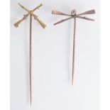 A gold crossed oars pin and a gold crosses rifles pin.