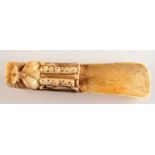 An oriental carved bone scoop.