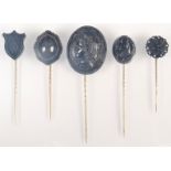 A carved jet cameo pin and four other jet pins.