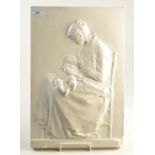 A moulded plaster plaque showing a mother breastfeeding a child, 47 x 31cm.