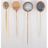 An intaglio finial pin, a moss agate set gold pin and two other pins with stone finials.