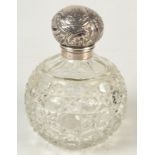 A cut glass spherical toilet bottle with silver hinged cover,