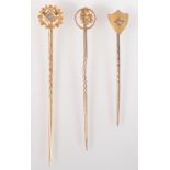 Three late Victorian gold pins, the finial of each set a single diamond.