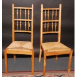 A pair of David Savage light oak, turned spindle back dining chairs,