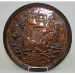 A Newlyn copper charger with intricate repousse and chased decoration of a galleon in full sail