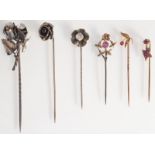 A 15ct. gold pearl and ruby flower pin and five other flower pins, mostly silver.