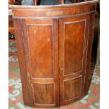 A George III mahogany hanging bow front corner cupboard.