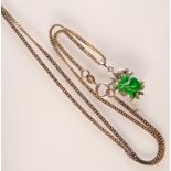 A platinum pendant set with carved jade and diamonds on a silver chain.