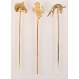 An 18ct. gold rearing horse pin and a 9ct. gold horse's head pin together with a 9ct.