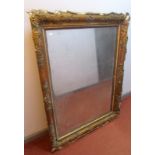 A 19th century mirror with bevelled glass in a gilt frame moulded with grapes and vine leaves,