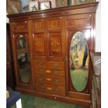 A fine late Victorian or Edwardian wardrobe in mahogany with seaweed marquetry panels and satinwood
