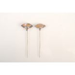 Two Japanese fan shaped pins with gilt mother of pearl panels.