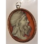 An antique classical miniature set gold pendant showing engrisaille a turbaned bearded male head on