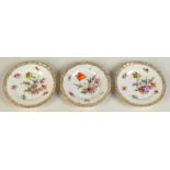 Three Dresden floral painted gilt border plates, diameter 15cm.