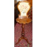 A Victorian walnut screen mounted occasional table with tripod base.