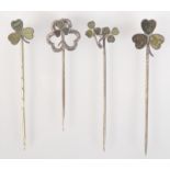 Four Irish green stone set silver souvenir pins.
