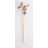 A Georgian style gold stick pin with a fruiting branch finial set with rose cut diamonds,