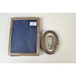 A modern, silver mounted photograph frame, together with a small oval,