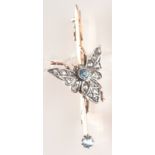 A late Victorian or Edwardian gold brooch mounted with an aquamarine and diamond fly.