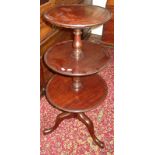 A George III mahogany three tier dumb waiter on tripod base.