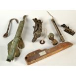 Heavy bronze shackles, a barbed steel hook and other items of maritime interest.