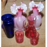 A pair of pink satin glass vases, three pieces of cranberry glass and a blue glass vase.