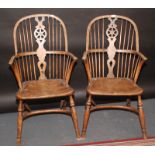 A pair of 19th century Windsor wheelback armchairs with elm seats.