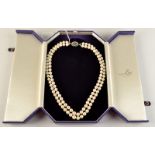 An impressive double strand pearl necklace with 18ct white gold clasp set with diamonds and