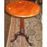 A Victorian walnut tripod table,