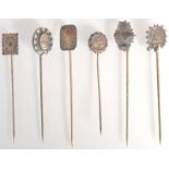 Six Victorian gold and silver Aesthetic Movement pins.