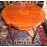 A Edwardian circular, inlaid table on square section legs joined by a low shelf, diameter 68cm.