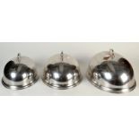 A set of three oval graduated meat covers.