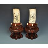 A pair of Japanese ivory tusk vases decorated in the Shibayama manner with mother of pearl and