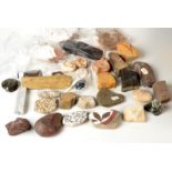A collection of archeological finds, including a black hematite hippopotamus head weight,