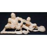 A Japanese ivory okimono, carved with a man and boy fishing, width 9.5cm.