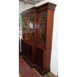 A Georgian style mahogany breakfront two tier bookcase with ebonised, reeded mouldings,
