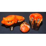 Three Leaper animals with running orange glaze.