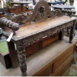 A carved oak hall bench.